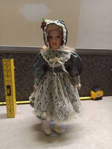 lot 370 image: Porcelain Girl Doll with Green Dress and Bonnet
