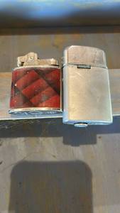 lot 6552 image: Pair of Collectible Pocket Lighters - Modenn Red Plaid and Silver Tone
