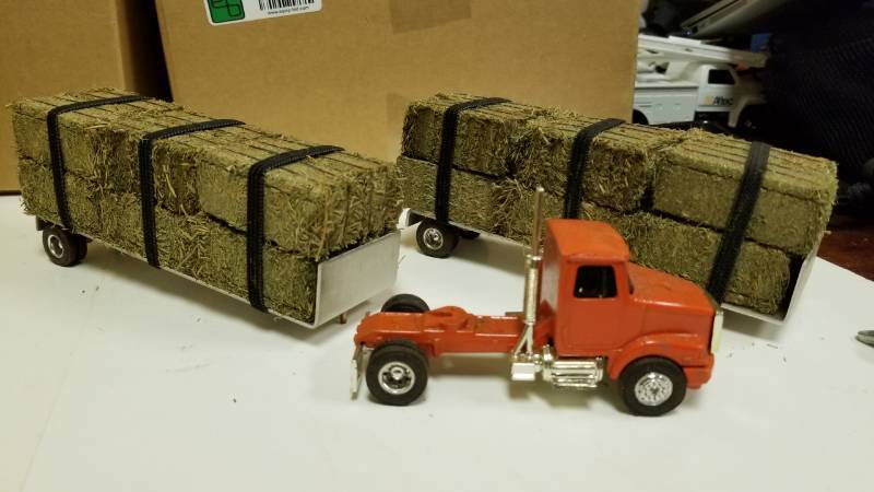 lot 1379 image: Ertl Cab with Hand Made Trailer and REAL bales of what smells like tobacco