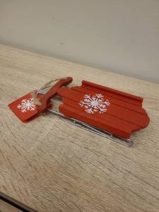 lot 40 image: Decorative Red Wood Sled with Snowflake Design