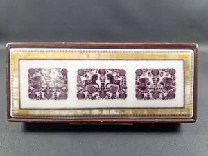 lot 2 image: Rectangular Vintage Music Box Adorned with Ceramic Tile Designed by Norwegian Artist Gramstad Oliver Approximately 12 by 5 inches
