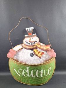 lot 51 image: Metal Snowman Welcome Hanging Decor with Pocket for GreeneryCards Approximately 16 inches tall with 18 inch tall Hanging Wire