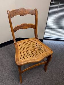 lot 10 image: Wood chair with cane seat (has tear)