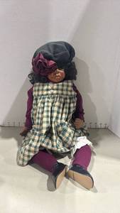 lot 1122 image: African American Porcelain Girl Doll with Checkered Dress