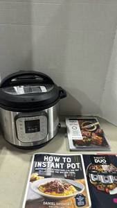 lot 1194 image: Instant Pot Duo Series Multi-Use Pressure Cooker with Cookbooks and Accessories