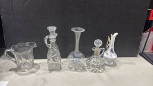 lot 1205 image: Collection of Glass Decanters, Vases, and Creamer with Porcelain Pitcher tallest is 8 inches