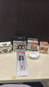 lot 1209 image: Kitchen Gadget Lot - Gravy Fat Separator, Egg Holder, Bagel Holder, Multi-Grater, Meat Thermometer & Strainer