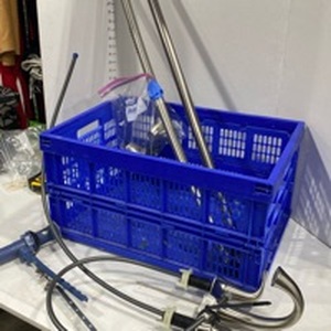 lot 2102 image: Faucet, curved shower rod and tension rod with crate