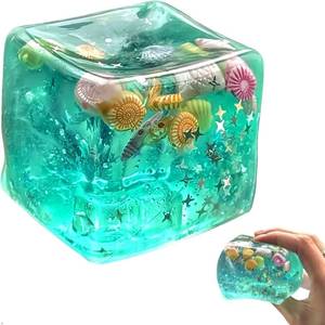 lot 2064 image: Solis Convene Ice Cube Cube Fidget Toys - Sensory Toys for Kids with Real Sea Shells, Squishy Fidget Toy for Kids & Adults  Non-Toxic Squeeze Ball for Anxiety, Focus & Calm for School, Office