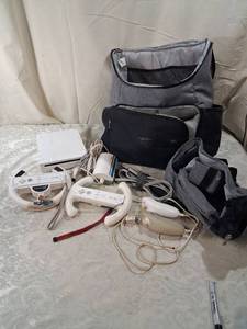 lot 11 image: Nintendo Wii Console Bundle with Controllers, Wheels, and Carry Bags