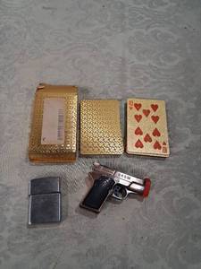 lot 41 image: Gold Foil Playing Cards, Novelty Pistol Lighter, and Chrome Flip Lighter Set