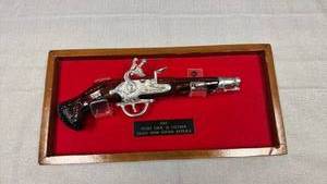 lot 45 image: Framed mounted 1765 flint lock .36 cal glass Avon replica 7.5 x 15 in (frame is loose on one corner)