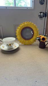 lot 7 image: English Castle Bone China Sunflower Tea Cup and Saucer Set with small metal pitcher with sunflowers in it and a picture frame shaped like a sunflower