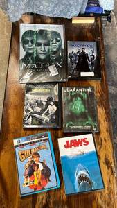 lot 73 image: Austin Powers in Goldmember (WS) (DVD Infinifilm Widescreen) DVD , the matrix movie with a matrix metal sign to go with the movie the movie swordfish, quarantine, and Jaws also included