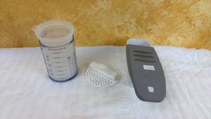 lot 152 image: Pampered Chef Cheese Grater with Container, Measuring Cup, and Cleaning Brush Set