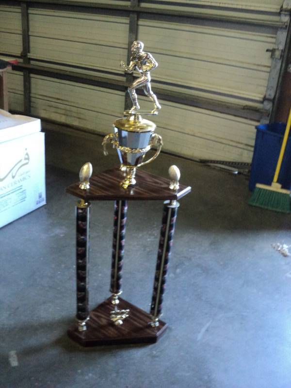 lot 4062 image: 2- Tier Football Corner Trophy 10-12 x 10-12 x 41 tall-- re-purpose this for your favorite arm chair quarterback Damage to cup, see photos