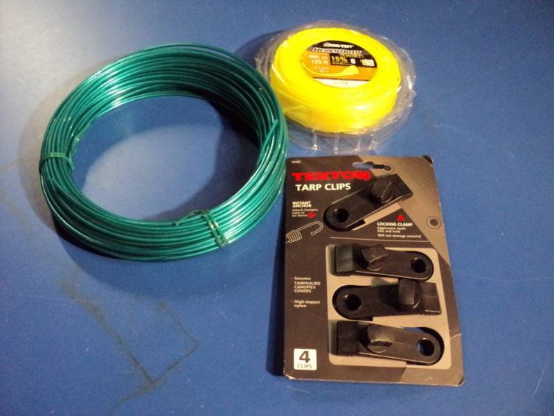 lot 4546 image: Mixed lot (1) 25 roll wire, Nylon coated for trees, (1) pkg. Ring Tuff heavy Duty 0.095 x 125 weed eater string (1) pkg. Tekton Tarp Clips, 4 clips per package