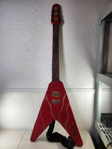 lot 115 image: Flying V-Style Electric Guitar Body Red Crackle Finish with Strap Art Piece