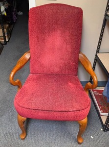 lot 24 image: Red Upholstered Armchair with Curved Wood Arms - some fade on the fabric on the back, but sturdy condition. 28W x 30D x 42H. Seat height 19H