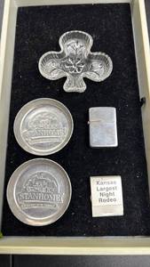 lot 108 image: Stanhome Embossed metal coasters, Clover Dish ashtrays, Zippo Pocket Lighter & Kansas Largest Night Rodeo Matchbook