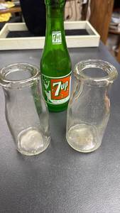 lot 119 image: 7up Glass Bottle with perforated metal shaker corked lid (metal has a little bit of a bow in it) and Two Vintage Glass Milk Bottles