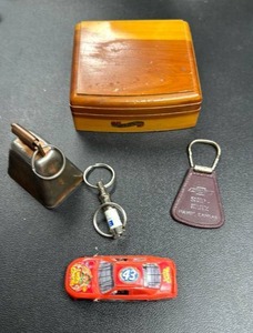 lot 122 image: Wooden Trinket Box, Keychains including a Cow Bell, and Die-Cast Car