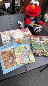 lot 143 image: Elmo rock plush character with plastic guitar and Vintage Puzzles including the Bobbsey Twins, Germany Scene and more