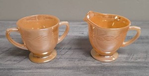 lot 410 image: Fire King Peach Luster Cream and Sugar set