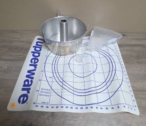 lot 414 image: Baking Lot- Angel Food Cake Pan with Bundt Tube Center, Tupperware rolling mat, pie or pizza slice storage, and Glasco measuring glass