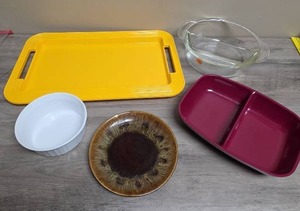 lot 433 image: Yellow Plastic Serving Tray, Small White Ceramic Casserole Dish, Clear Glass Bowl with Divider, Red Plastic Divider Bow, and a vintage plate