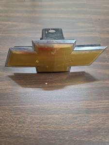 lot 945 image: Gold and Chrome Chevrolet Emblem Hitch Insert (gold has a little bubbling damage)