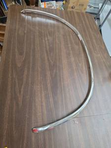 lot 964 image: GM Chrome Curved Wheel Arch Trim Molding Strip approx. 34 in. arc - (was in official GM packaging, but the packaging was disintegrating)