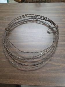 lot 1000 image: Barbed Wire Coil - maybe about 8-10 ft