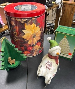 lot 505 image: Holiday Decor Lot  - Large Poinsetta Tin, Snowman Figurine, Tree Votive Holder (in box), and wood corner tree with a small wood reindeer