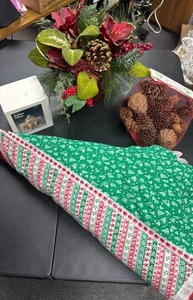 lot 509 image: Traditions Holiday Village Town Opera Center (corded w lights), bag of pine cones, artificial flowerpine cone arrangement, and a Christmas tree skirt