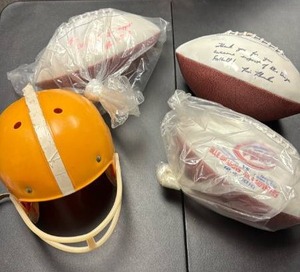 lot 757 image: Salt City Bowl Commemorative Footballs and a Vintage Childs Football Helmet (has a crack in it)