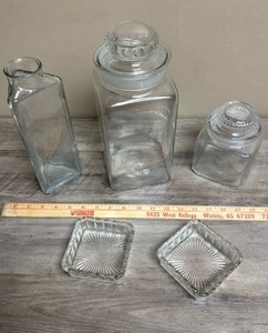 lot 533 image: Two Glass Cannister jars with lids, tall glass jar, and two square glass coasters