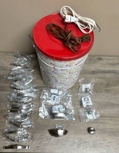 lot 580 image: Karmelkorn Tin with Red Lid, two electrical cords, and large lot of drawer pulls and knobs (pulls and knobs new in packages)