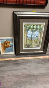 lot 605 image: Framed Print Window Scene and a print of The Jersey cow on wood backing