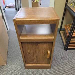lot 32 image: Wood Laminate Side Table with Shelf and Cabinet Door - 12 34 W x 11.5 D x 26 34 H - has wear on top laminate and minor bubbling