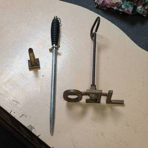 lot 112 image: Washington Mini Building Thermometer, Long Dagger shaped Poker, and a Branding Iron that says LEO