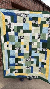 lot 35 image: Handmade Patchwork Quilt with Animal Print and Multi-Color Blocks Reversing to Chili Print