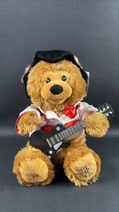 lot 92 image: Cuddle Barn Elvis Presley Teddy Bear Plush with Guitar Battery Operated Sound (untested)