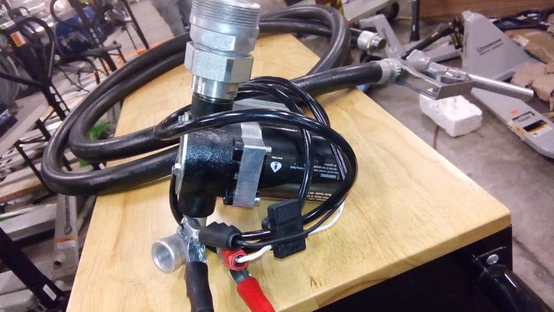 lot 7981 image: Roughneck 12V Fuel Transfer Pump  8 GPM, Manual Nozzle, Hose