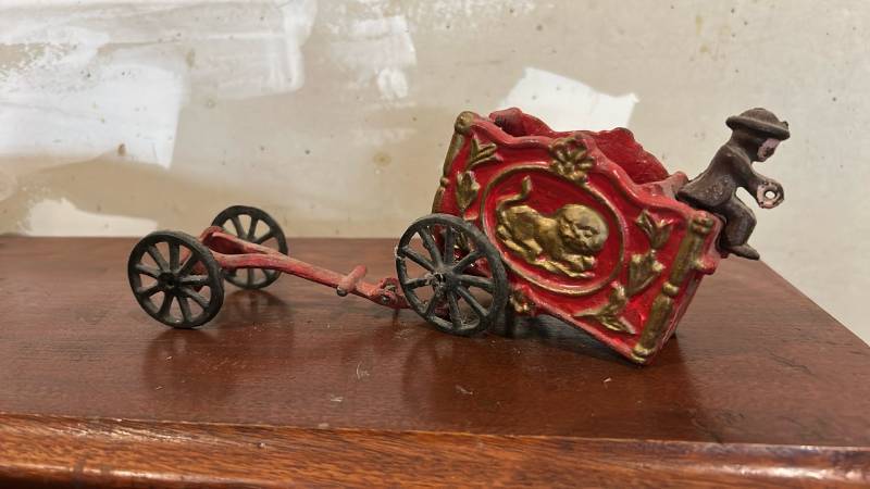 lot 60647 image: Cast Iron Circus Wagon Toy with Figure and Separate Wheel Carriage