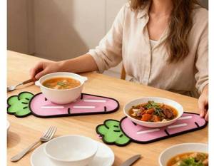 lot 28049 image: Pot Lid Mat, Adorable Carrot Design, 24x8cm, Silicone Pot Lid Holder, Countertop Utensil Trivet, Heat Resistant Material and Non Slip, for Holding Spatulas, Cutting Boards, Or Soap Daily Kitchen Use.  - Retail $15