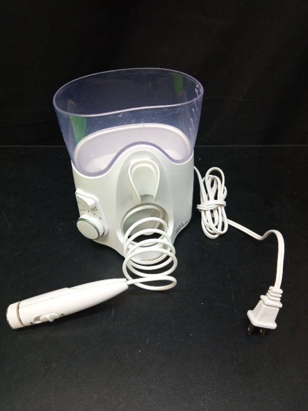 lot 1031 image: Electric Water Flosser with Reservoir Tank - Retail $25