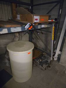 lot 18517 image: Contents of Shelf and Floor (Does Not Include Barrett Jack)- Two Boxes of Carpet Squares, Plastic Barrel with Lid, Steel Plates and Various Hardware