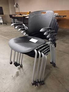lot 20006 image: Stacking Mobile Chairs with Perforated Black Seats, Silver Frames, and Black Arms - Set of 100