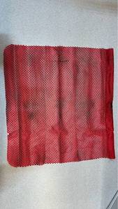 lot 7732 image: Red Mesh fabric on metal bar